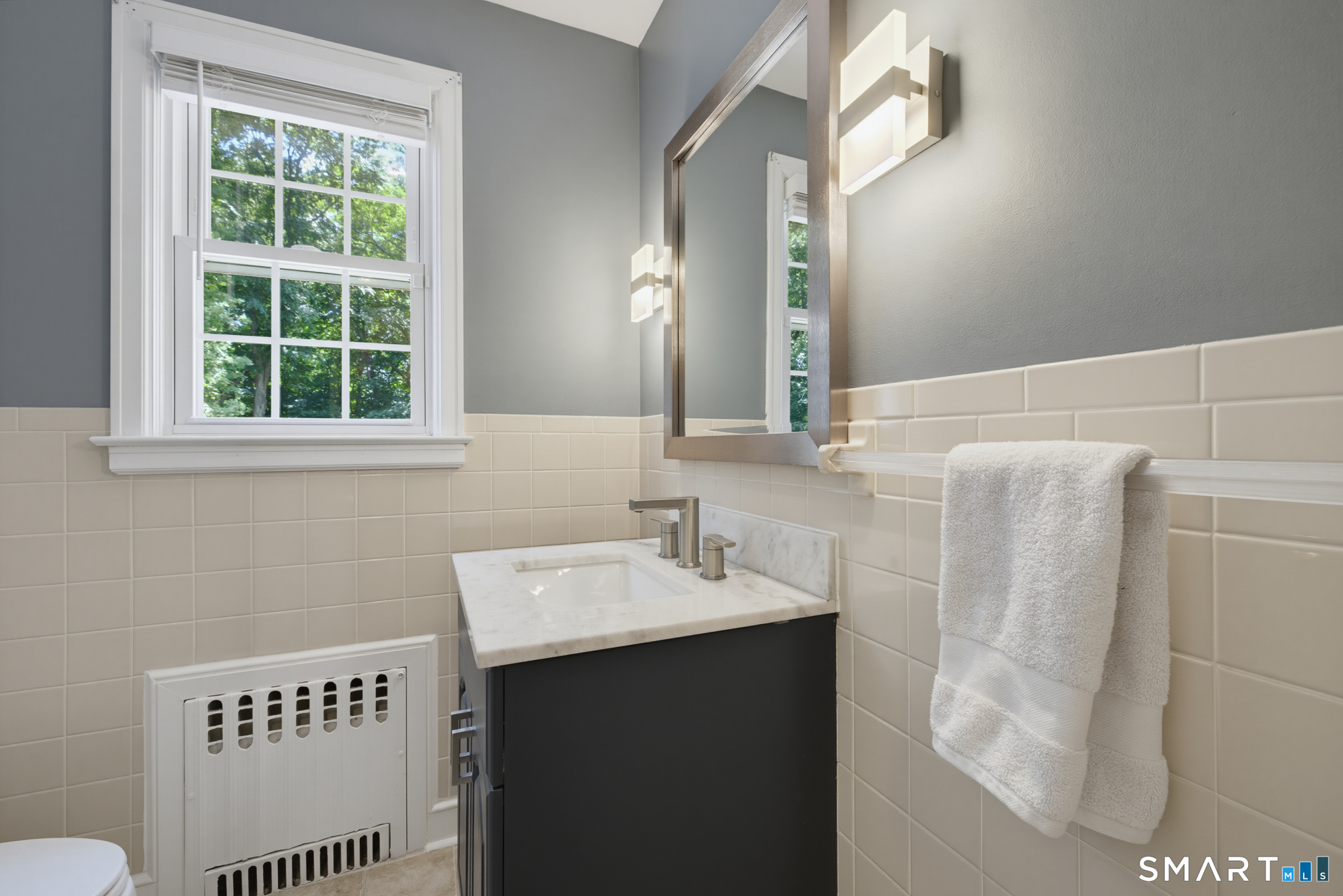 224 Spring Street Manchester, CT 06040 - Photo 14 of 39 a bathroom with a sink a toilet and a mirror