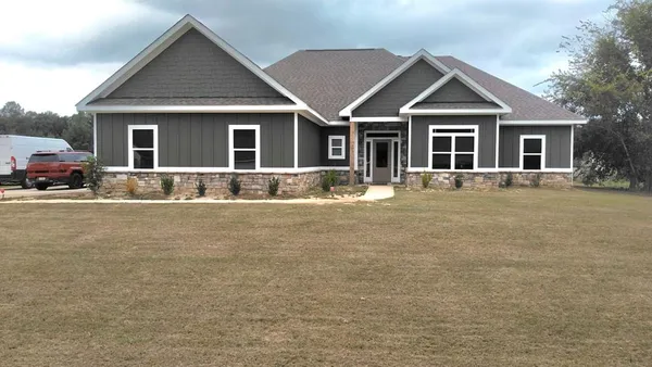 a front view of a house with a yard