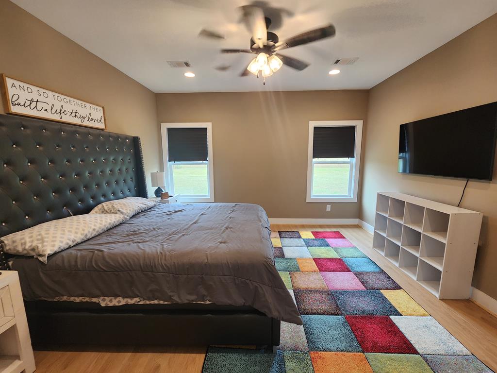 152 McLendon Road Fort Mitchell, AL 36856 - Photo 11 of 27 a bedroom with a bed and a flat screen tv