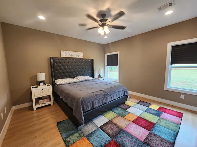 a bedroom with a bed and a chandelier