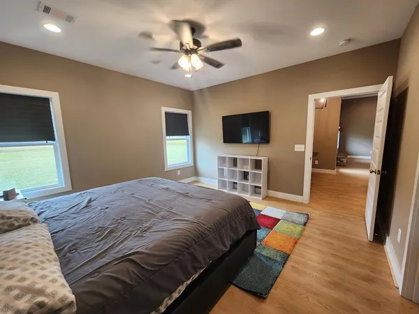 a bedroom with a bed and a flat screen tv