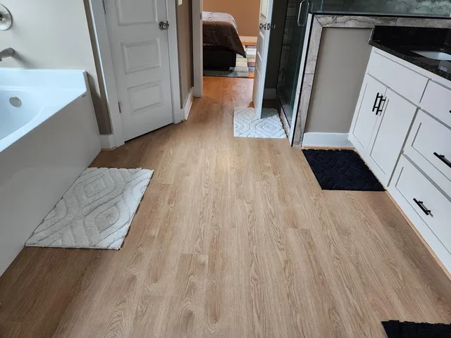 a view of hallway with wooden floor and stairs