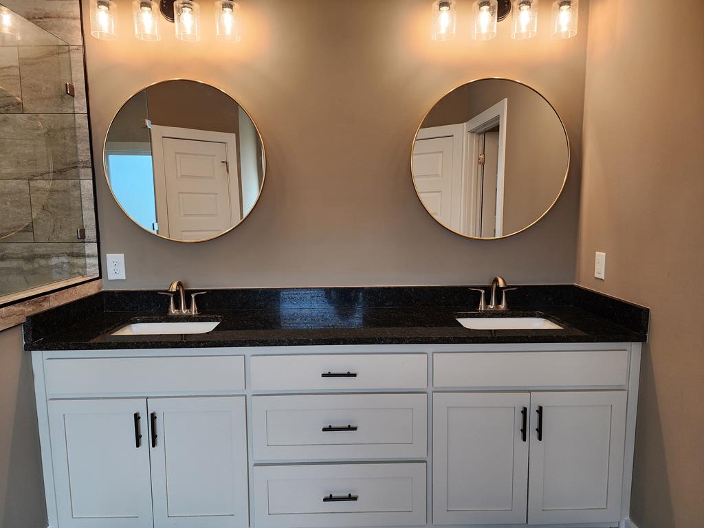 152 McLendon Road Fort Mitchell, AL 36856 - Photo 16 of 27 a bathroom with a granite countertop double vanity sink and a mirror