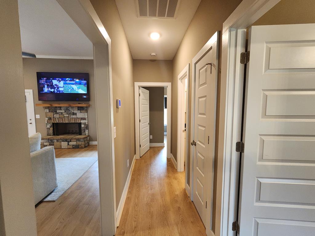 152 McLendon Road Fort Mitchell, AL 36856 - Photo 18 of 27 a view of a hallway with wooden floor and a living room