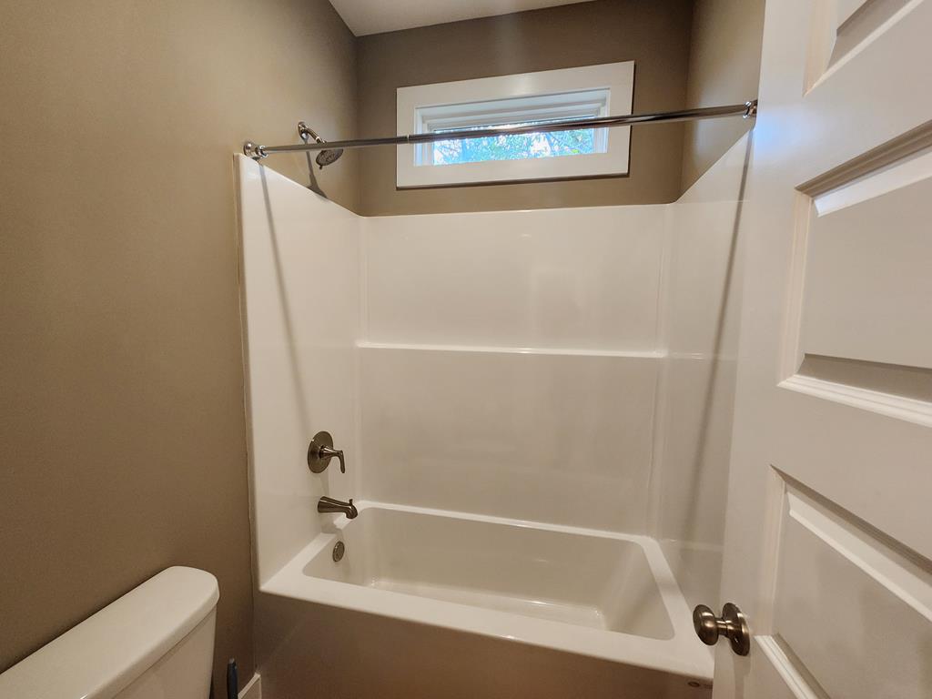 152 McLendon Road Fort Mitchell, AL 36856 - Photo 21 of 27 a bathroom with a bathtub and a shower