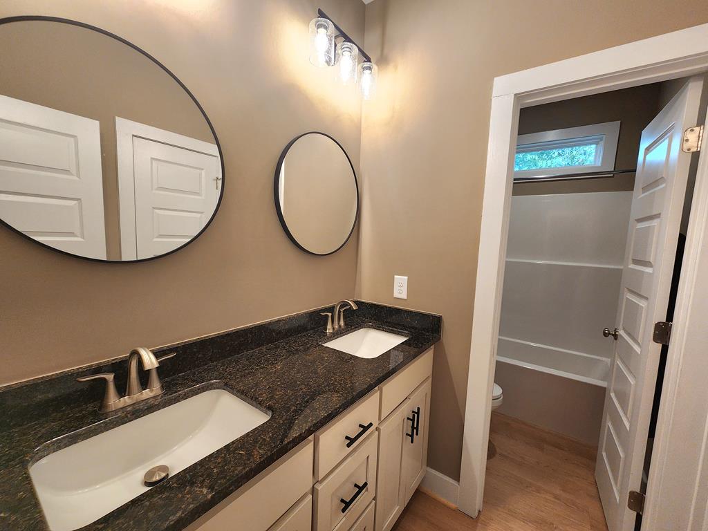 152 McLendon Road Fort Mitchell, AL 36856 - Photo 22 of 27 a bathroom with a granite countertop sink and a mirror