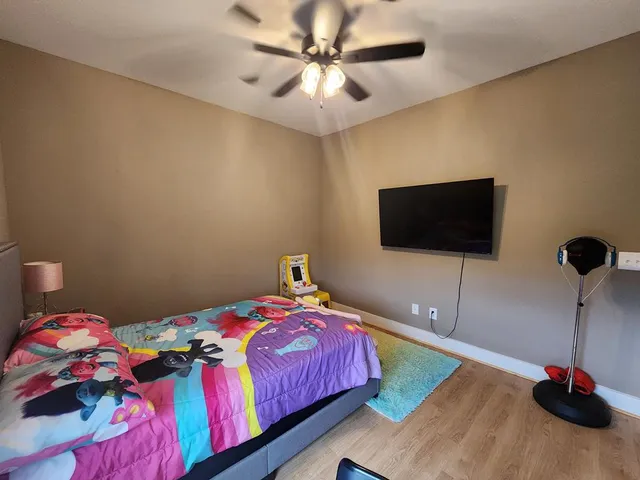 a bedroom with a bed and a flat screen tv
