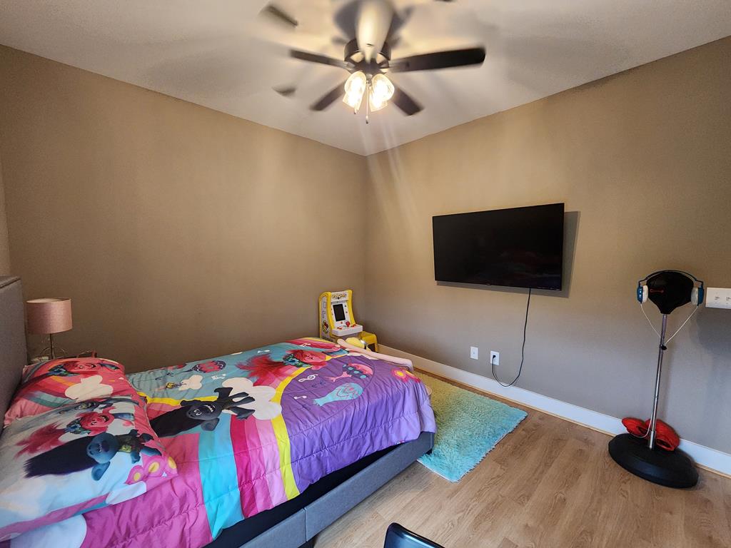 152 McLendon Road Fort Mitchell, AL 36856 - Photo 23 of 27 a bedroom with a bed and a flat screen tv