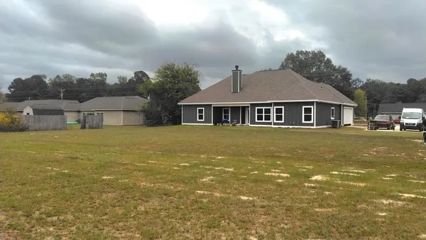 a front view of a house with a yard table and chairs