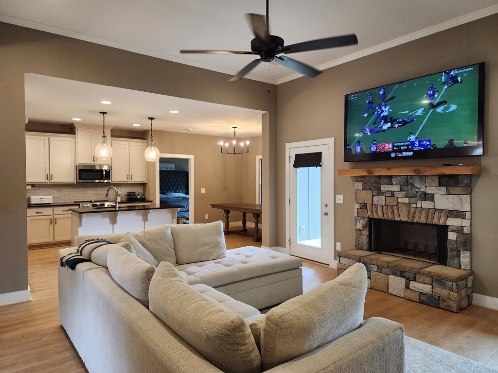 152 McLendon Road Fort Mitchell, AL 36856 - Photo 6 of 27 a living room with furniture a flat screen tv and a fireplace