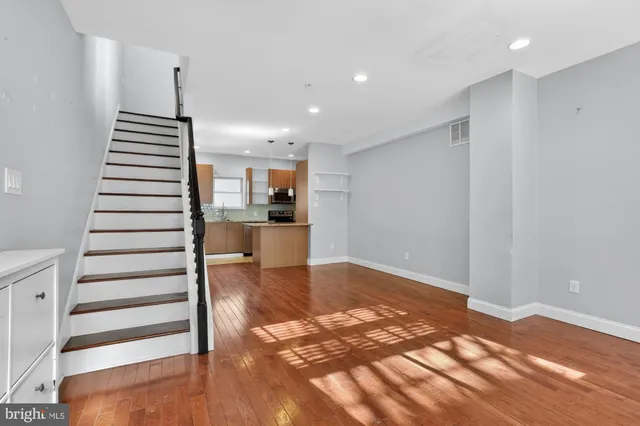 a view of a kitchen with wooden floor and a sink