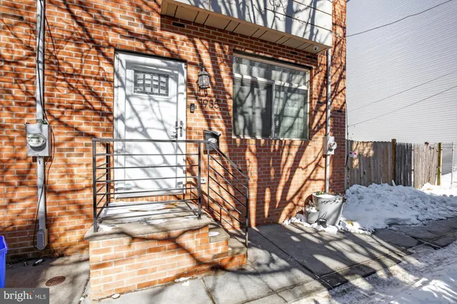 a view of a brick house with a tree