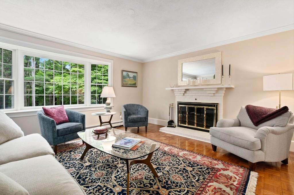 228 Cochituate Road Wayland, MA 01778 - Photo 13 of 32 a living room with furniture a rug a fireplace and a large window