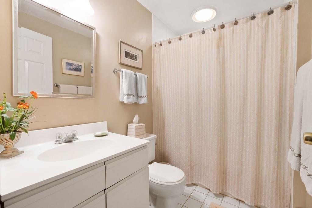 228 Cochituate Road Wayland, MA 01778 - Photo 14 of 32 a bathroom with a sink a toilet and shower curtain