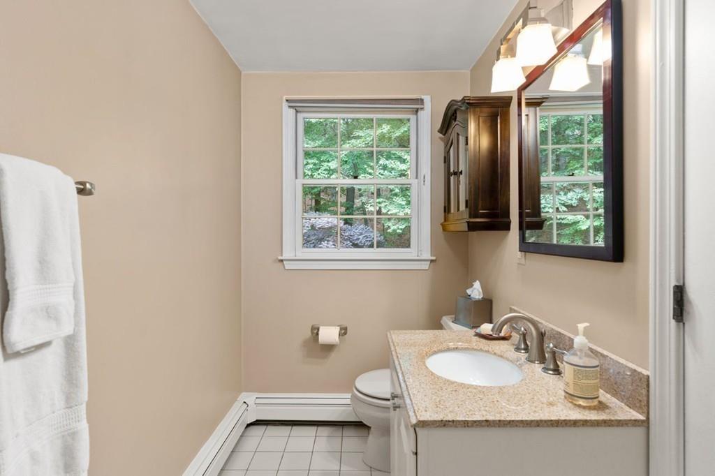 228 Cochituate Road Wayland, MA 01778 - Photo 23 of 32 a bathroom with a granite countertop sink toilet and mirror