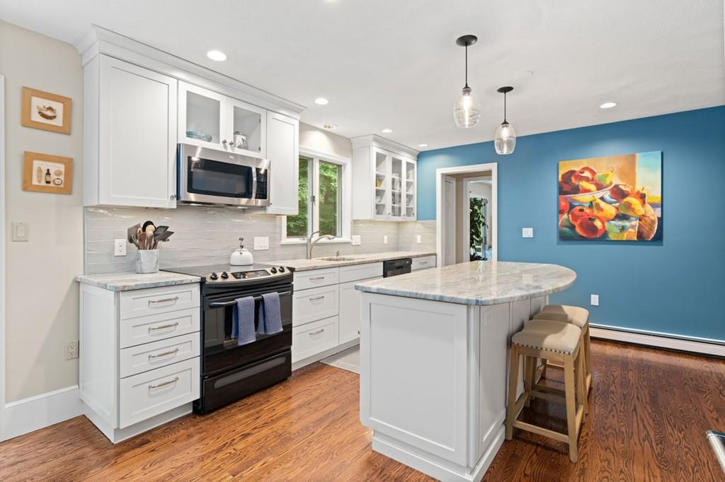 228 Cochituate Road Wayland, MA 01778 - Photo 5 of 32 a kitchen with kitchen island granite countertop a sink appliances and cabinets