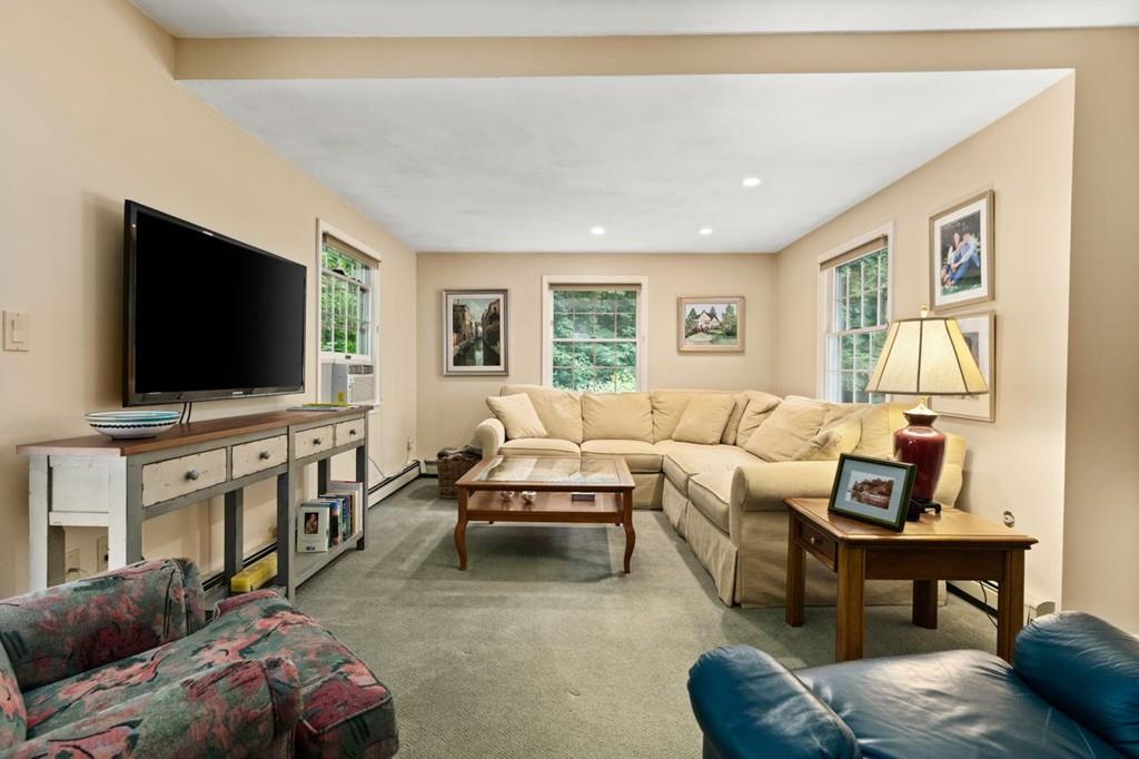 228 Cochituate Road Wayland, MA 01778 - Photo 8 of 32 a living room with furniture and a flat screen tv