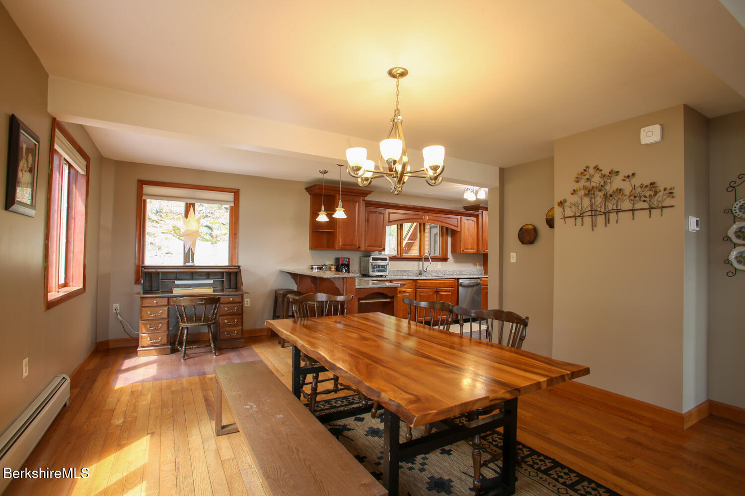 421 Legate Hill Road Charlemont, MA 01339 - Photo 9 of 37 a dining room with wooden floor a chandelier a wooden table and chairs