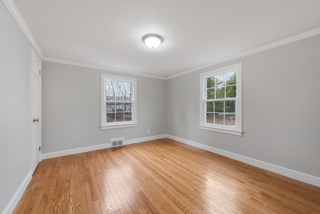 438 Tinkham Road Springfield, MA 01129 - Photo 12 of 23 a view of an empty room with wooden floor and a window