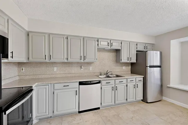 a kitchen with appliances cabinets and a sink
