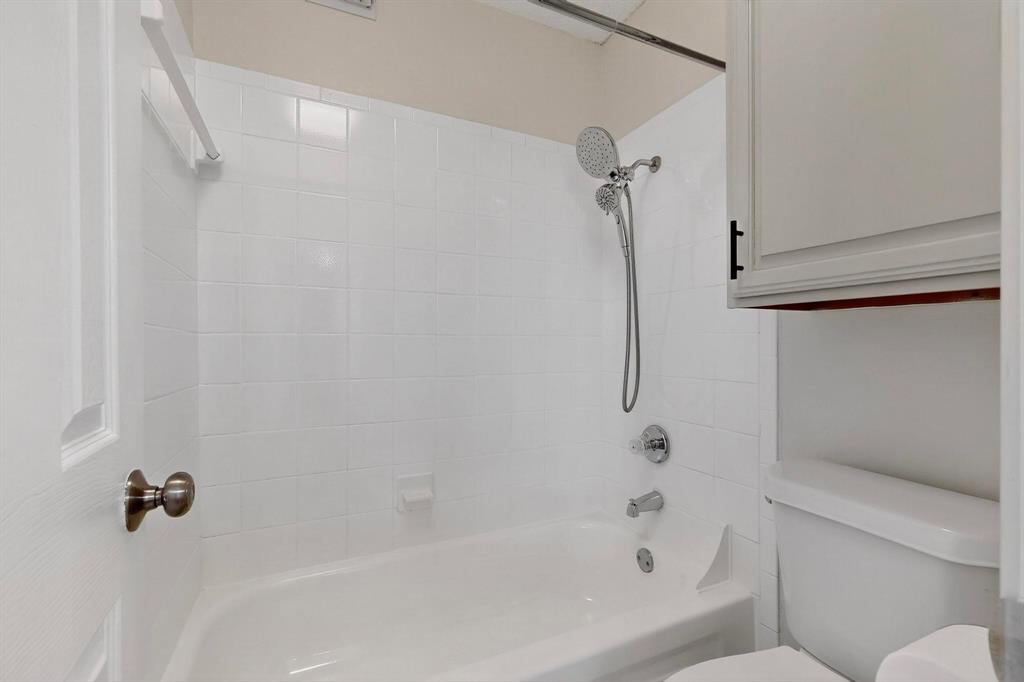 5840 Spring Valley Road, Unit 810 Dallas, TX 75254 - Photo 20 of 40 a bathroom with a shower and a toilet
