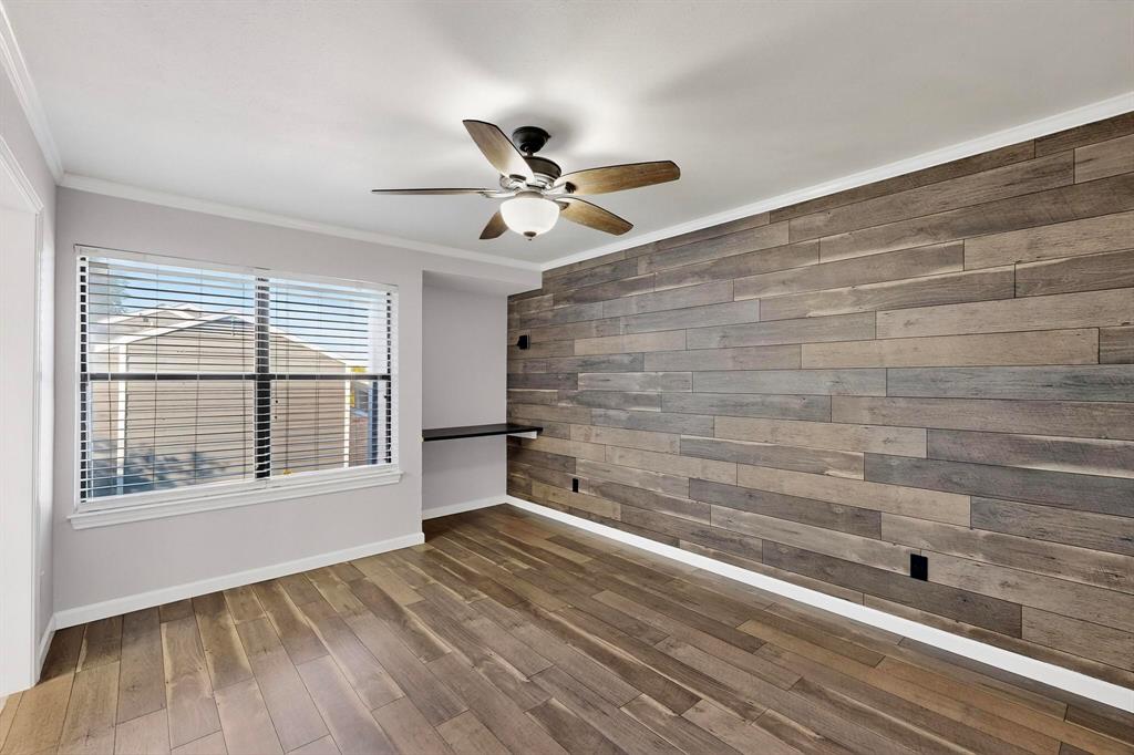 5840 Spring Valley Road, Unit 810 Dallas, TX 75254 - Photo 22 of 40 a view of an empty room with a window and wooden floor