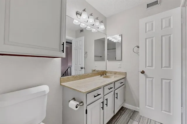a bathroom with a sink a vanity and a mirror