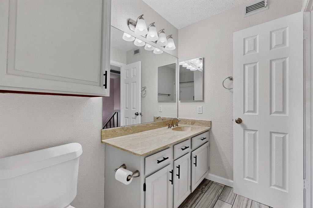 5840 Spring Valley Road, Unit 810 Dallas, TX 75254 - Photo 24 of 40 a bathroom with a sink a vanity and a mirror
