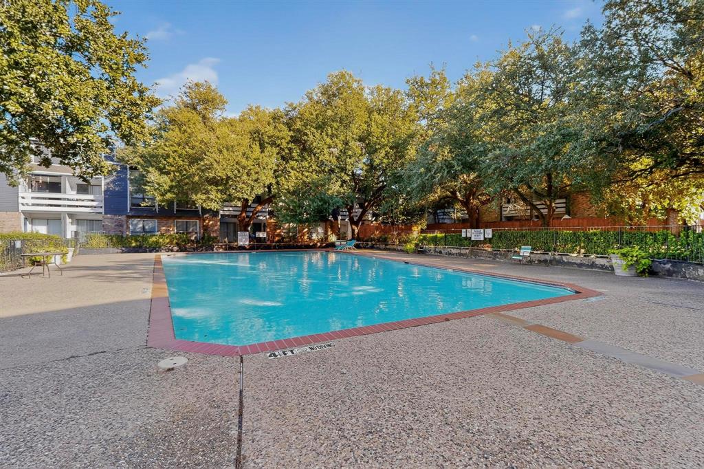 5840 Spring Valley Road, Unit 810 Dallas, TX 75254 - Photo 38 of 40 a view of a swimming pool with an outdoor seating and a yard