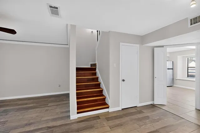 a view of a room with wooden floor and white doors