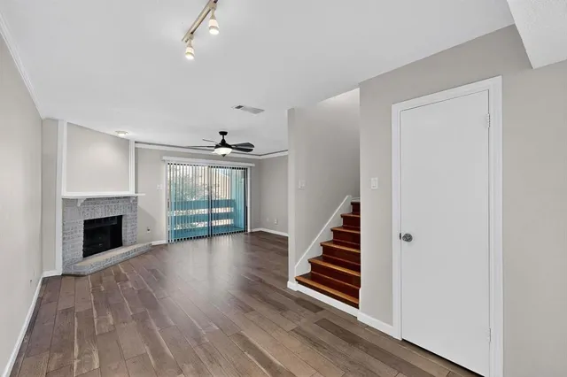 wooden floor in an empty room with a fireplace