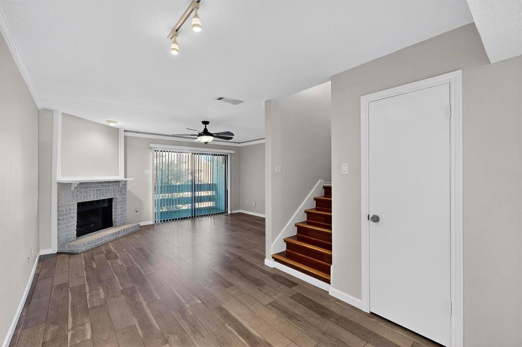 5840 Spring Valley Road, Unit 810 Dallas, TX 75254 - Photo 10 of 40 wooden floor in an empty room with a fireplace
