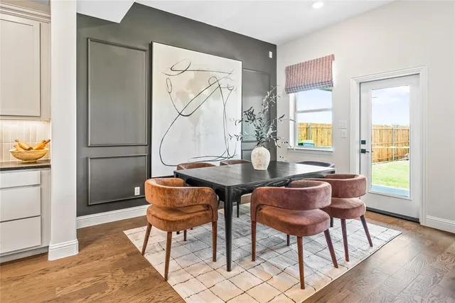 a living room with furniture a fireplace and a large window