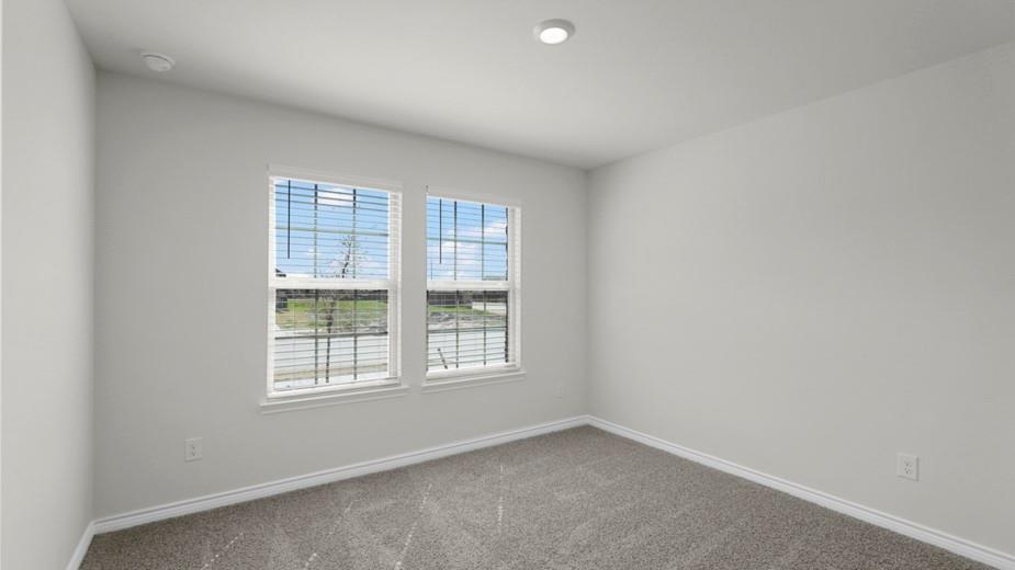 439 Epiphany Lane Lavon, TX 75166 - Photo 26 of 31 Light gray carpeted room with dual windows featuring white blinds, white trim, and a recessed ceiling light