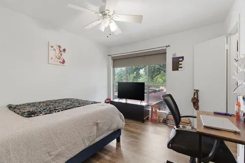 a bedroom with a bed and a chandelier