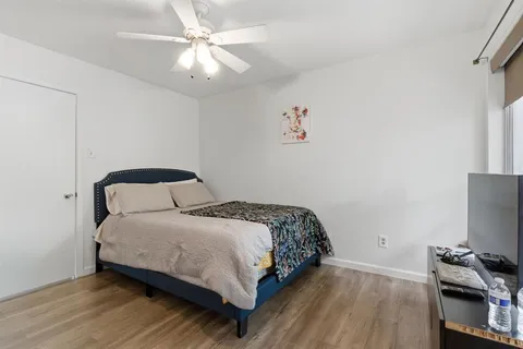 a bedroom with a bed and a chandelier