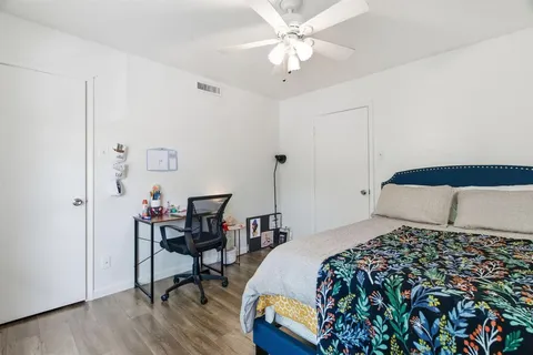 a bedroom with a bed and wooden floor