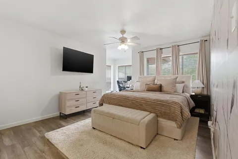 a bedroom with a large bed and a chandelier