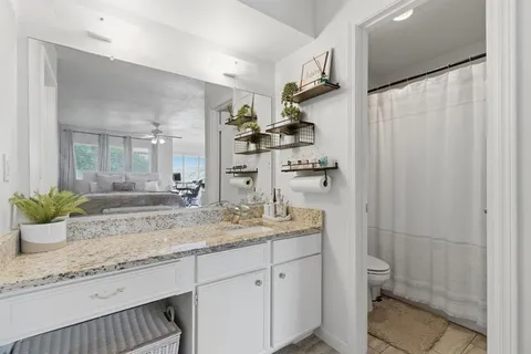 a white toilet sitting next to a shower