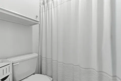 a en suite bathroom with a granite countertop sink mirror and shower