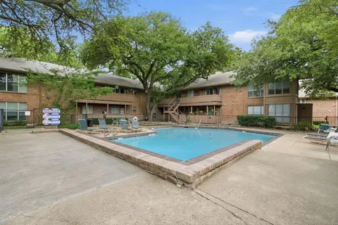 a view of a patio with swimming pool table and chairs