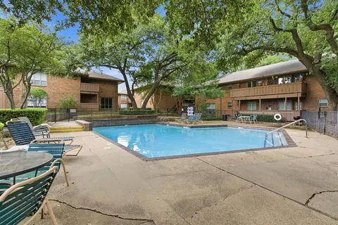 a view of a house with pool and chairs