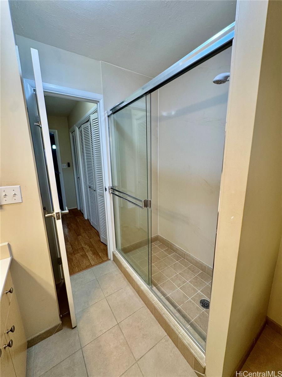 369 Opihikao Place, Unit 352 Honolulu, HI 96825 - Photo 20 of 25 a bathroom with a glass door shower and a sink
