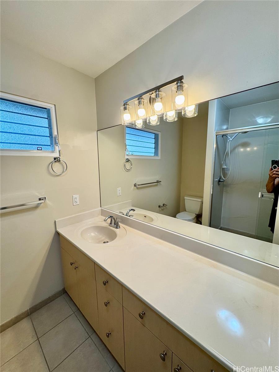 369 Opihikao Place, Unit 352 Honolulu, HI 96825 - Photo 21 of 25 a bathroom with a sink and a mirror