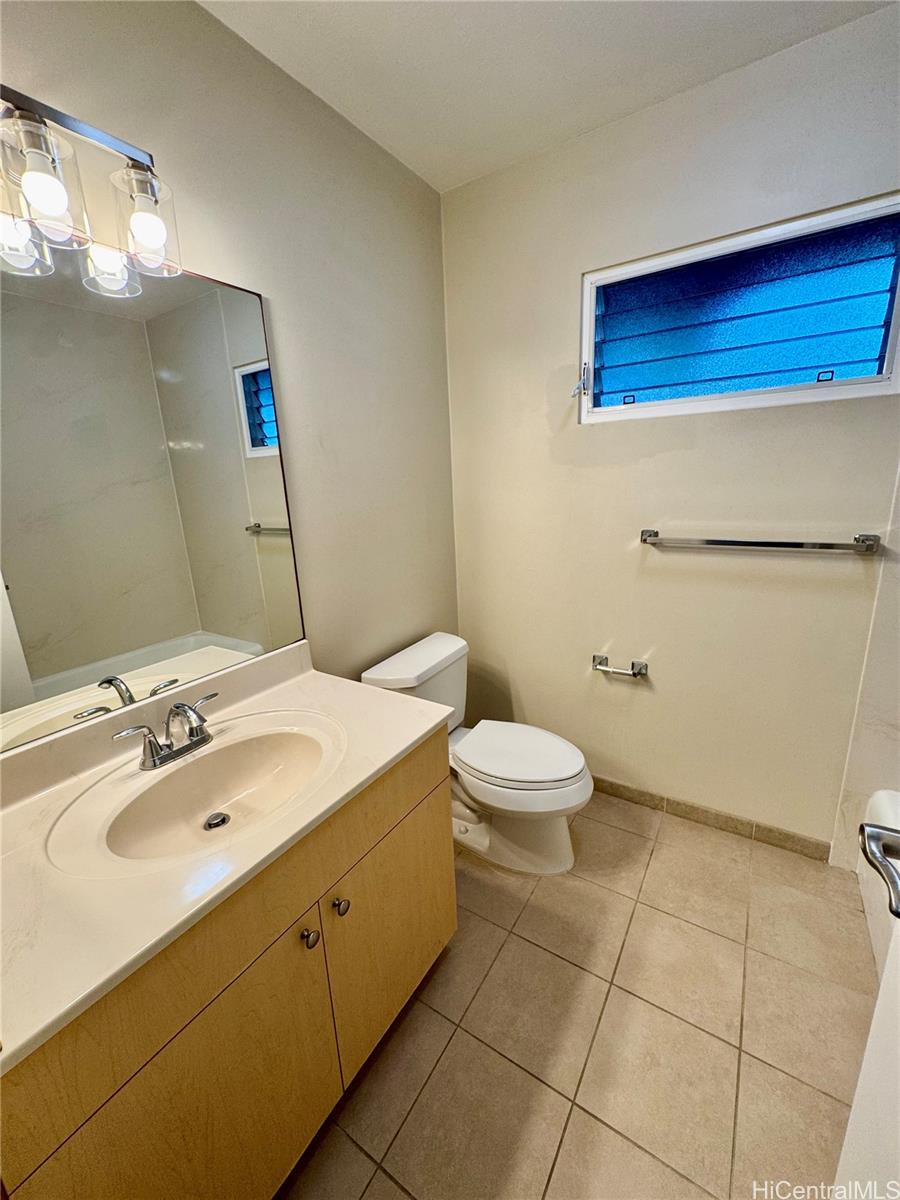 369 Opihikao Place, Unit 352 Honolulu, HI 96825 - Photo 24 of 25 a bathroom with a sink a toilet and mirror