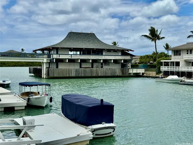a front view of a house with a garden and car parked