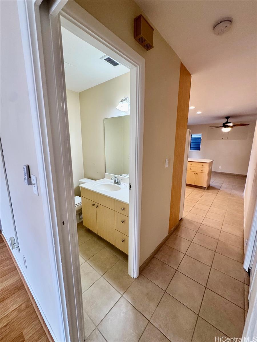 369 Opihikao Place, Unit 352 Honolulu, HI 96825 - Photo 8 of 25 a bathroom with a sink a mirror and a toilet