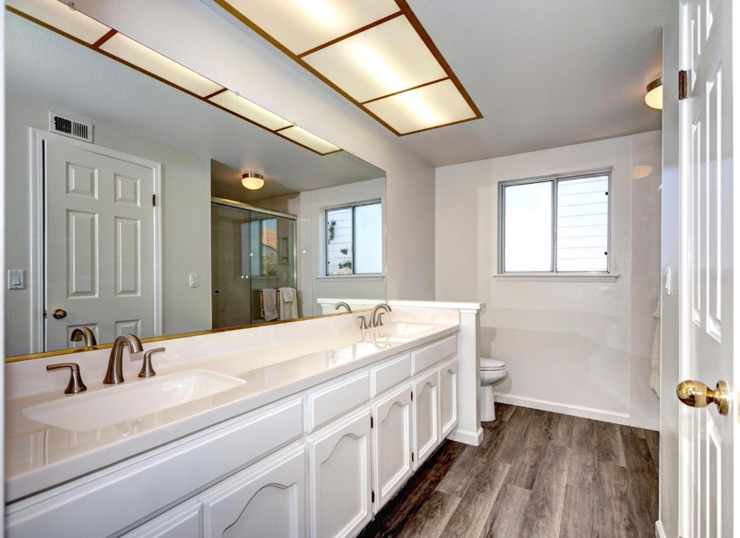 2201 Pinard Street Milpitas, CA 95035 - Photo 13 of 26 a en suite bathroom with a double vanity sink and a mirror