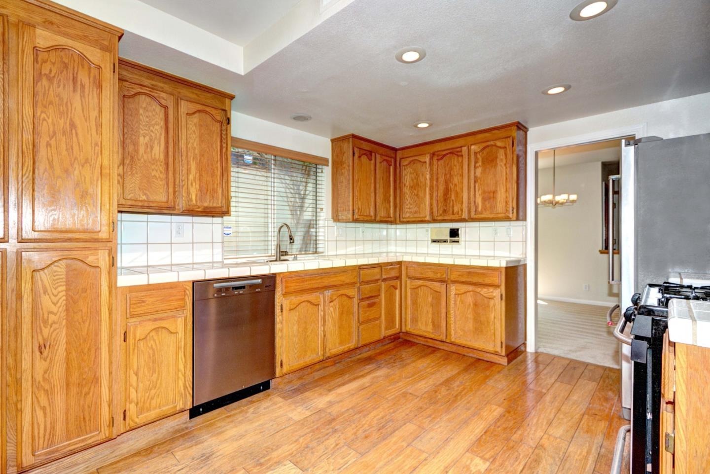 2201 Pinard Street Milpitas, CA 95035 - Photo 7 of 26 a kitchen with stainless steel appliances granite countertop wooden cabinets a refrigerator and sink