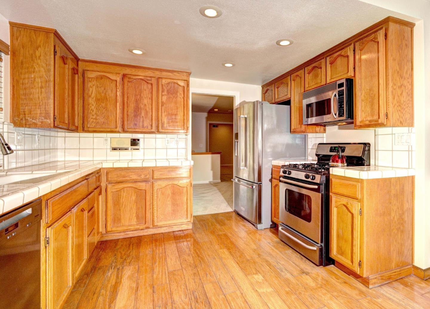 2201 Pinard Street Milpitas, CA 95035 - Photo 8 of 26 a kitchen with stainless steel appliances a stove a sink and a microwave